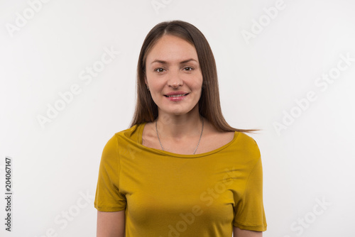 Pretty woman. Pleasant beautiful woman looking at you while standing against white background