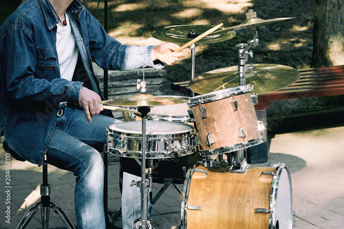 A street musician playing drums in the summer.
