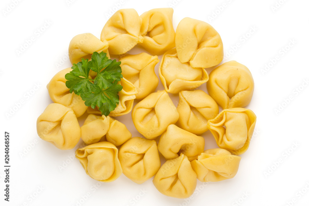 Raw homemade pasta,tortellini with herbs.
