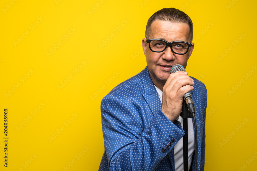 © F8  \ Suport Ukraine - Portrait of mature man singing on yellow background