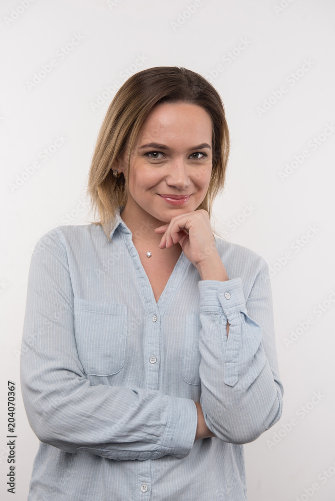Beautiful lady. Happy delighted woman touching her chin while looking at you Beautiful lady. Happy delighted woman touching her chin while looking at you