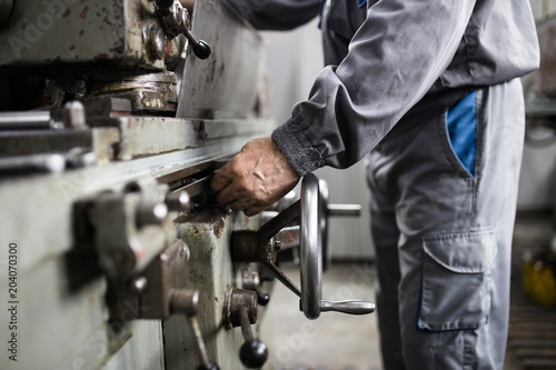 Metallurgy heavy industry. Factory for production of special industrial tools. Worker hands close up.