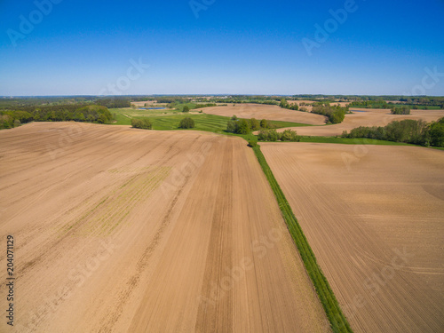 aerial view of freshly plowed agricultural fields ready to sowing