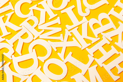 White letters. Letters on a yellow background. English alphabet.