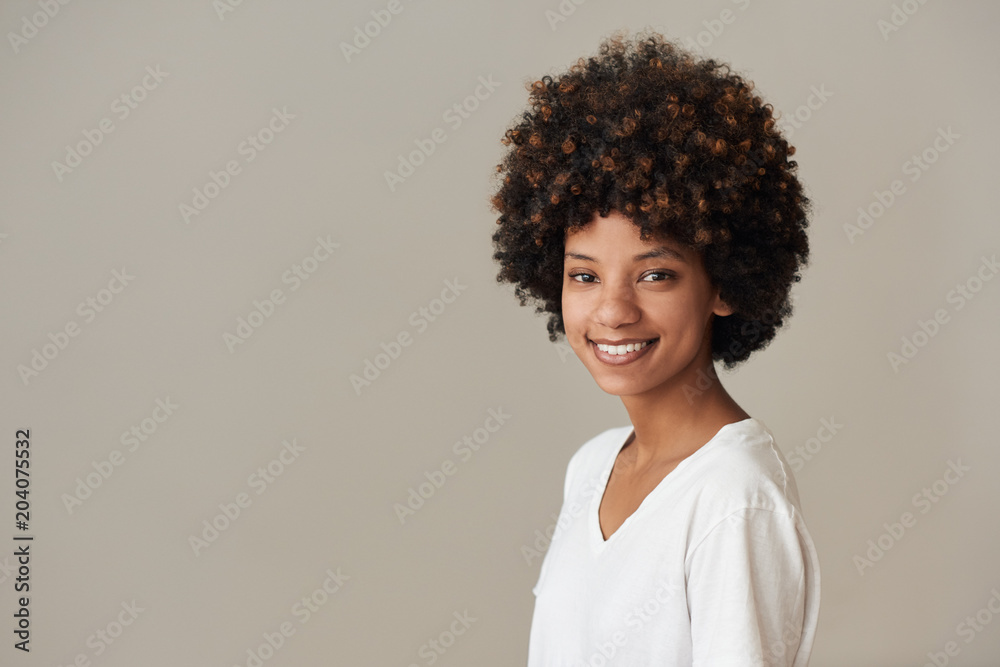 Smiling African woman with an afro and natural complexion Smiling African woman with an afro and natural complexion