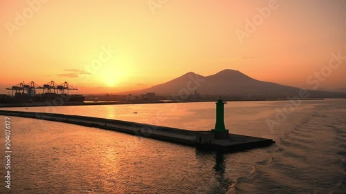 sailing to the port of Naples at sunset with Vesuvius in the background. italy