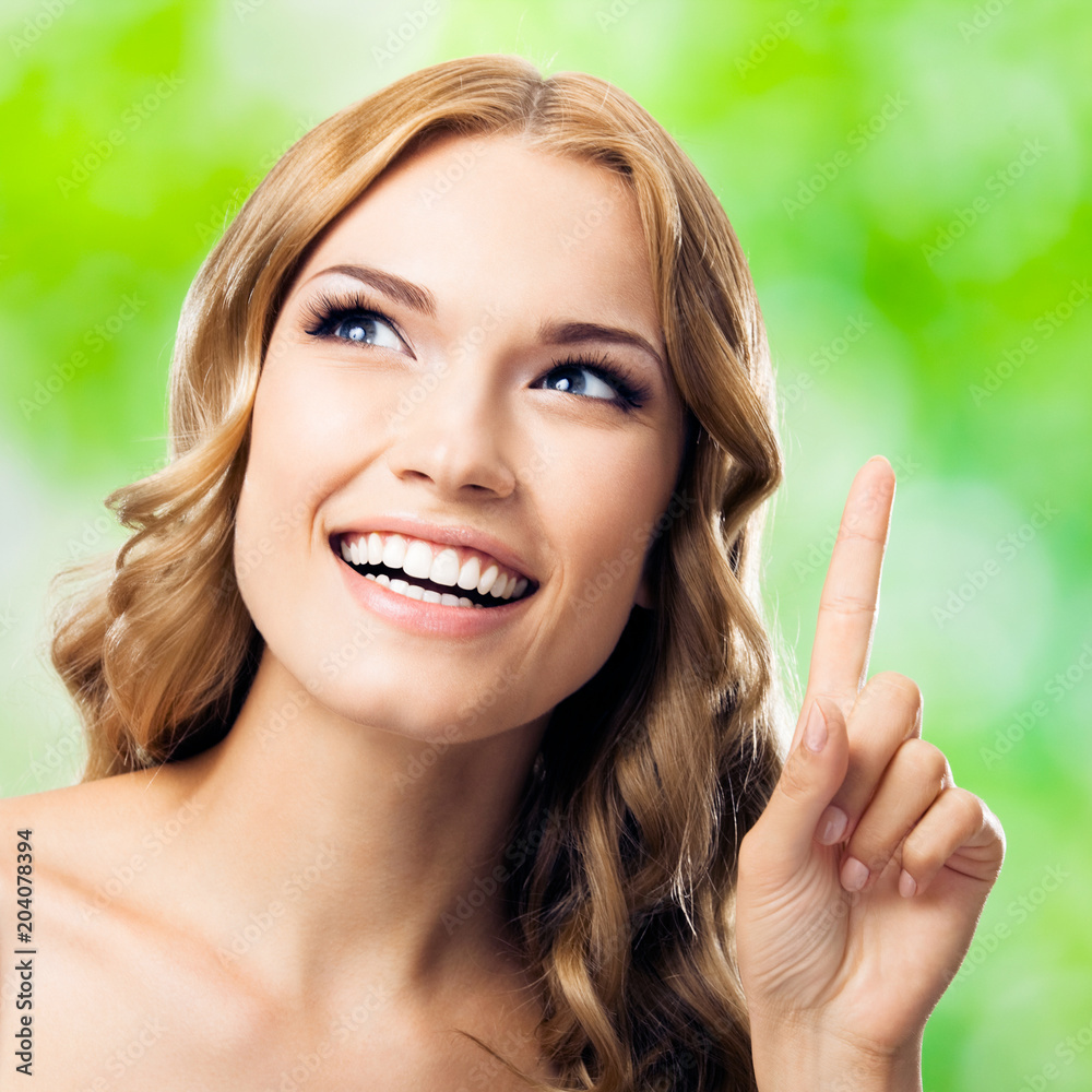 Woman, showing one finger or idea gesture, outdoor Woman, showing one finger or idea gesture, outdoor