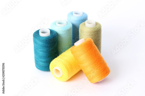 sewing thread of different colors isolated on white.