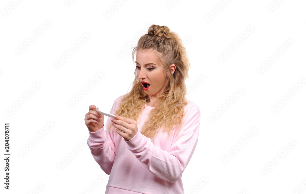Shocked upset woman looking at pregnancy test Shocked upset woman looking at pregnancy test