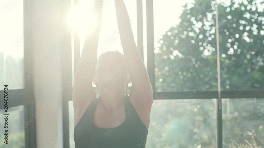 Asian woman practice yoga pose in sunny studio high key shot rapid slow motion Asian woman practice yoga pose in sunny studio high key shot rapid slow motion