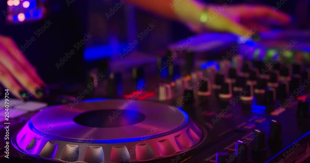 Girl Dj Playing at a Nightclub in Slow Motion Girl dj perfoming on a party. She's beautiful and energetic, dressed in stylish clothes Girl Dj Playing at a Nightclub in Slow Motion Girl dj perfoming on a party. She's beautiful and energetic, dressed in stylish clothes