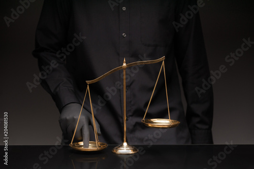 Man pressing the imbalance scale photo