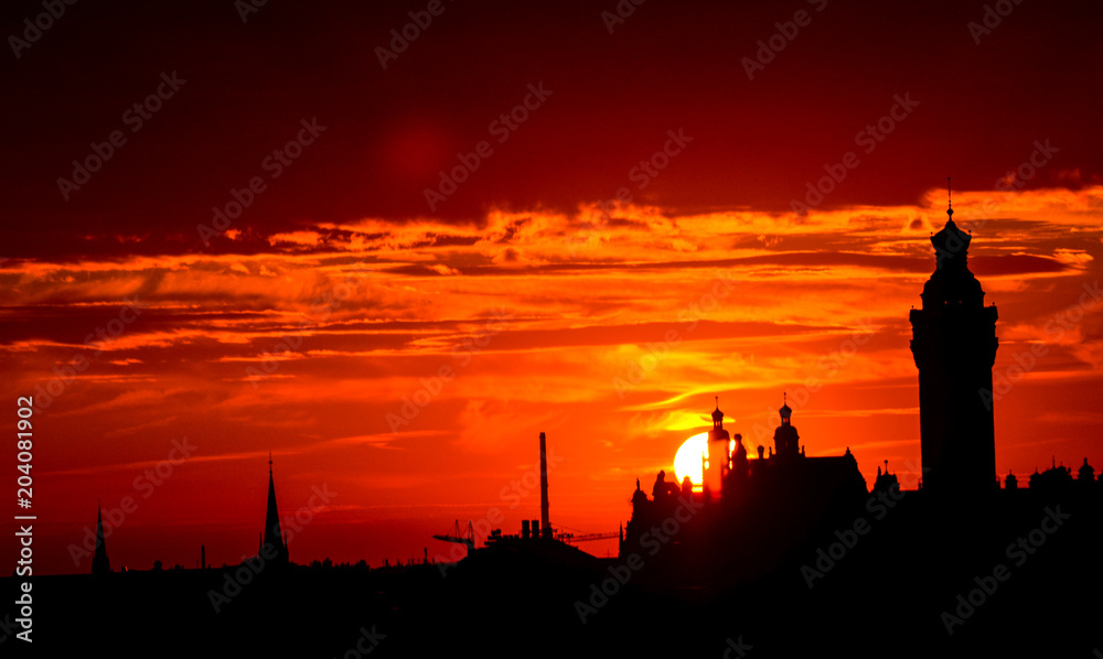 Naklejka premium Sunset behind the city hall, highlighting the skyline of Leipzig, Germany