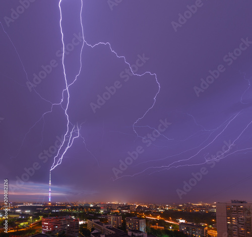 Moscow  Ostankino district  Russia. Lightning beating in the Ostankino TV tower. Rain  storm and light in the night city. Dramatic sky