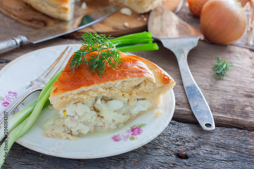 A cut piece of a closed pie from a yeast dough with fish (Rybnik), horizontal © Анна Журавлева