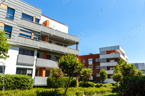 Exterior of a modern apartment buildings on a blue sky background. No people.