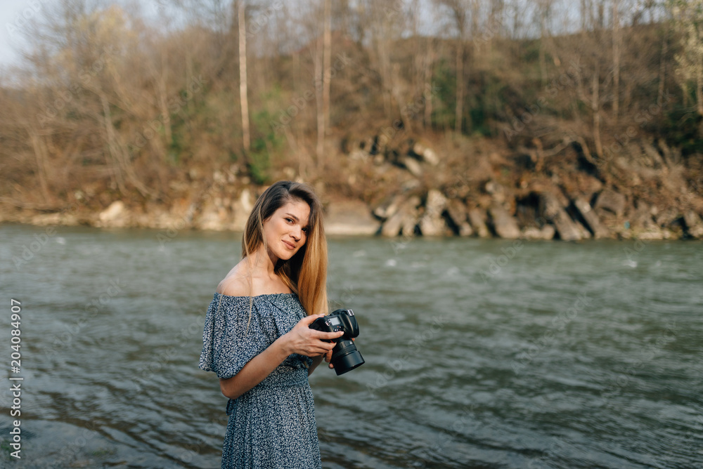 happy photographer standing by the river happy photographer standing by the river