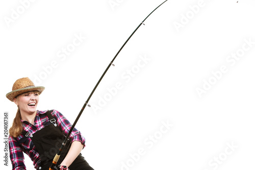 Focused woman in sun hat holding fishing rod