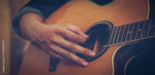Schilderij op canvas hand playing acoustic guitar, close up on musical instrument Relaxation Music sound hobby passion concept