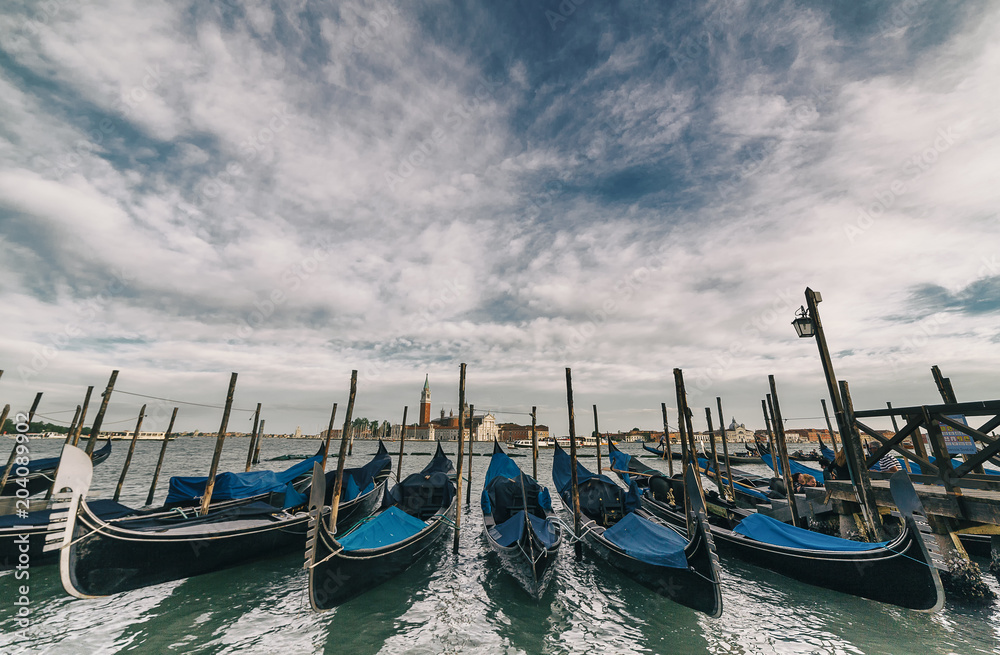 wide angle view of Traditional Gondolas in St Marco or Saint Mark's square in Venice