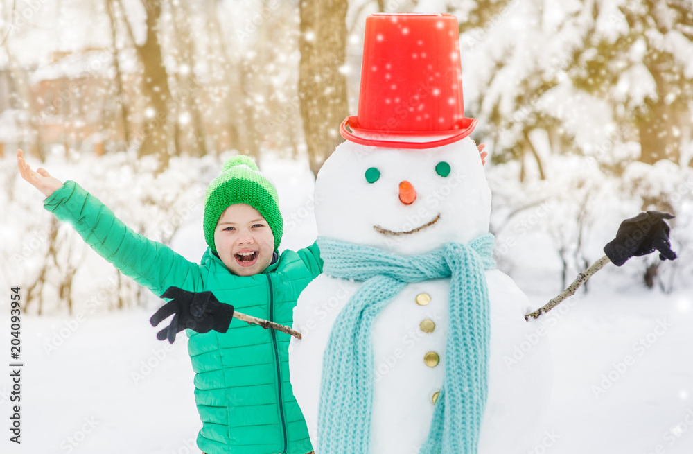 Joyful boy with snowman Joyful boy with snowman