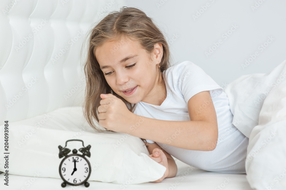 angry girl wants to break the alarm clock with her fist angry girl wants to break the alarm clock with her fist