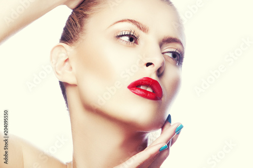 Beauty face of gorgeous girl hold hands near head. Bright red lips maje up, perfect skin. Beautiful young woman with blue nail polish manicure photo