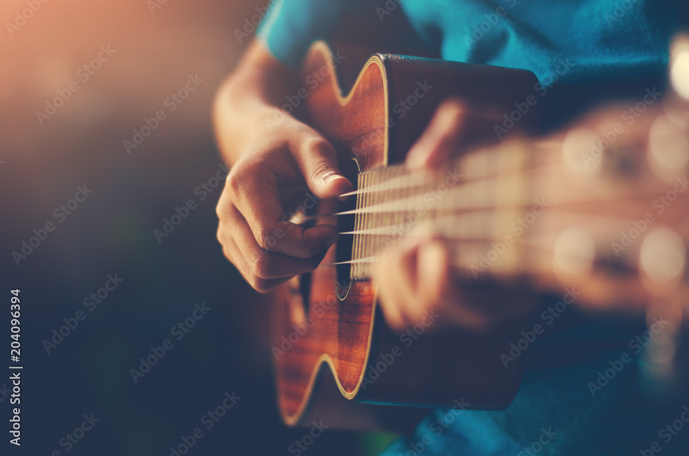 Hands playing acoustic guitar ukulele  - obrazy, fototapety, plakaty 