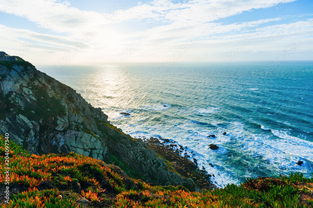 high rocky shore with large stones and sea water at the foot of the cliff high rocky shore with large stones and sea water at the foot of the cliff