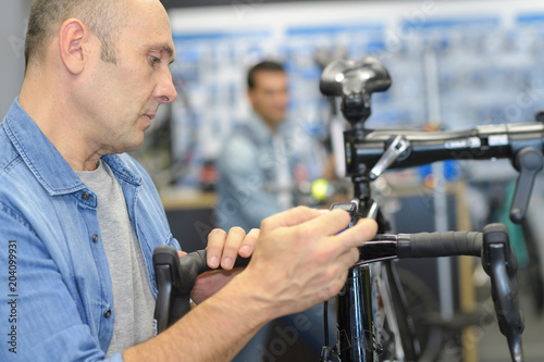 man checks a bike before buying in the sports shop