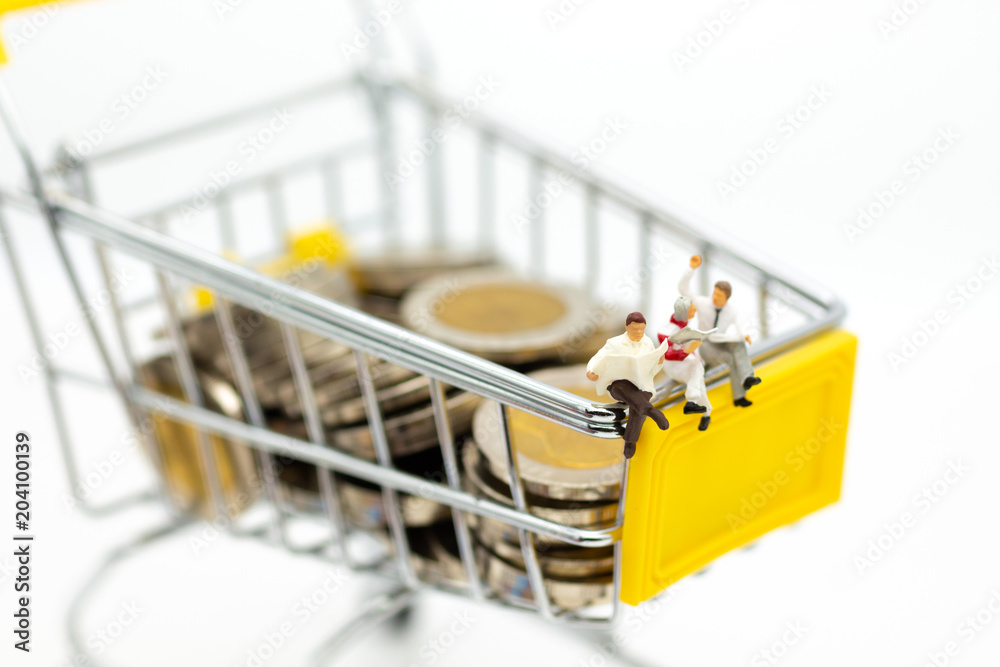 Miniature people : Businessman reading on shopping cart on stack of coin. Image use for retail business concept.