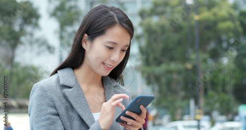 Business woman use of smart phone in city