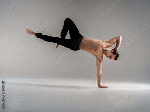 Modern ballet dancer performing art jump with empty copy space background, izolated photo