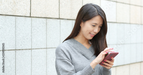 Photography Woman sending sms on cellphone