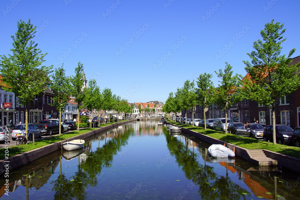 Oudegracht, against a clear blue sky, in the Dutch historic city of Weesp, North Holland, the Netherlands.