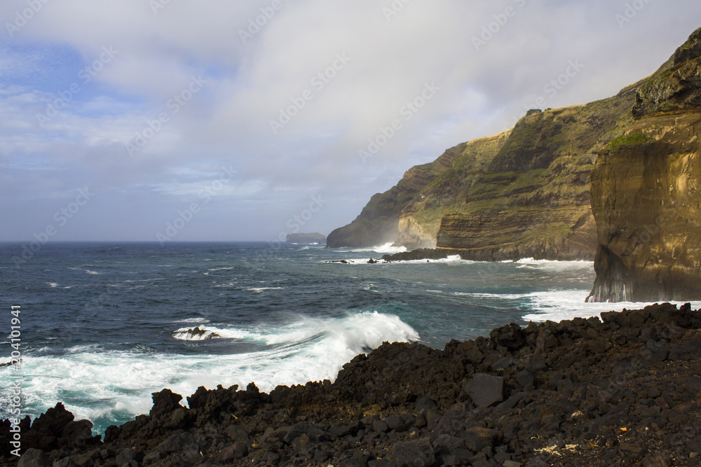 View of cliffs and seashore in volcanic area