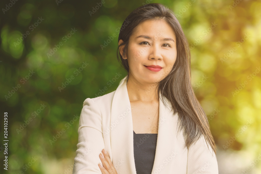 smart Asian business working woman standing outdoor in a park,smiling at a camera smart Asian business working woman standing outdoor in a park,smiling at a camera