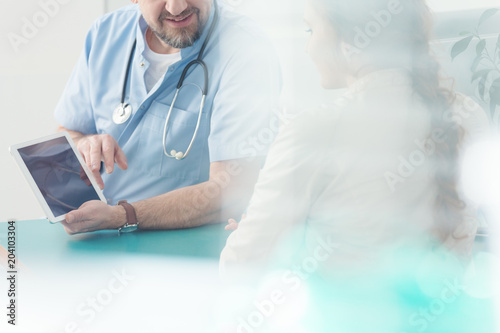 Surgeon showing information on tablet