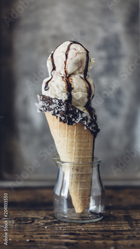 Waffle cone with vanilla ice cream in glass jar