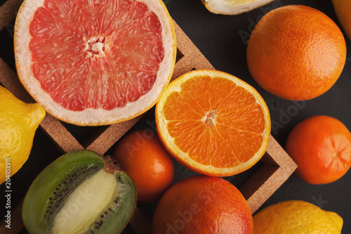 Variety of ripe citruses on gray background