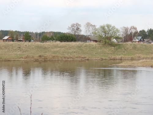 the banks of the spring river in the evening at sunset