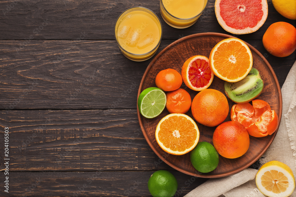 Variety of ripe citruses on wooden background Variety of ripe citruses on wooden background