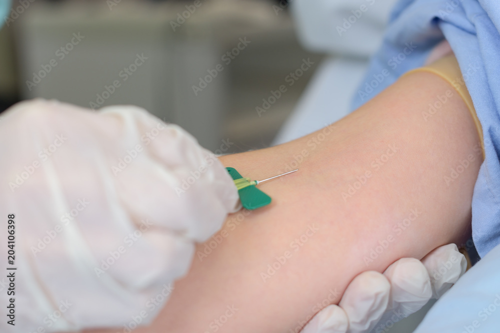 Needle being inserted into arm Needle being inserted into arm