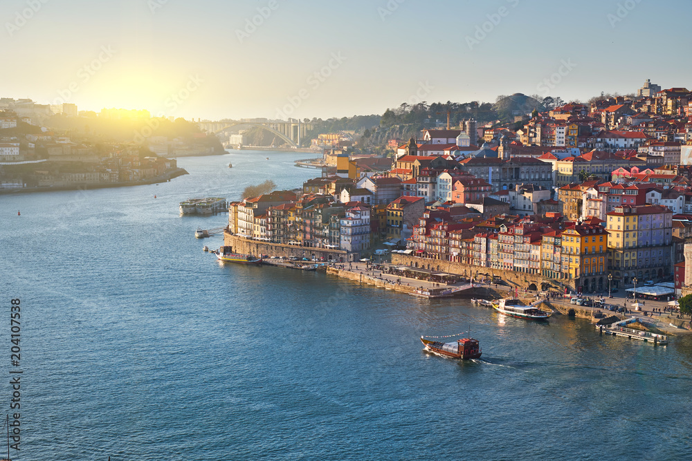 Porto city landscape. Douro river, boat at sunset, Portugal