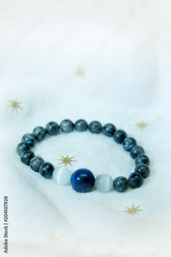 lapis lazuli bead and Labradorite Crystal lucky stone bracelet bead on white towel background.fashion with believe in Add charm,property, healthy in wonderful life. lapis lazuli bead and Labradorite Crystal lucky stone bracelet bead on white towel background.fashion with believe in Add charm,property, healthy in wonderful life.