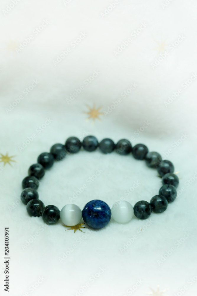 lapis lazuli bead and Labradorite Crystal lucky stone bracelet bead on white towel background.fashion with believe in Add charm,property, healthy in wonderful life. lapis lazuli bead and Labradorite Crystal lucky stone bracelet bead on white towel background.fashion with believe in Add charm,property, healthy in wonderful life.