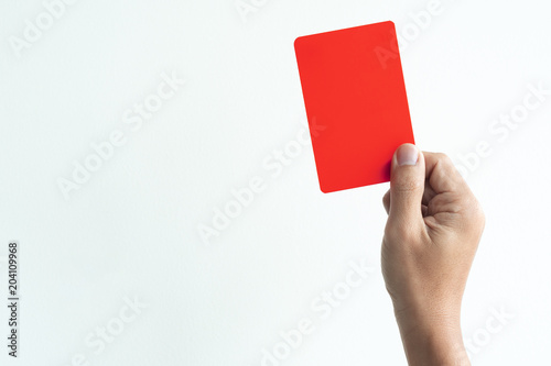 Hand is showing red card as in footbal rule penalty concept.