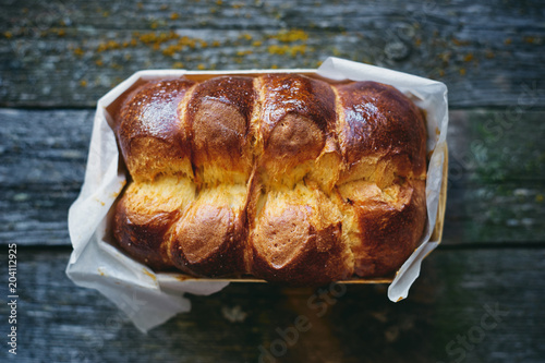 Delicious homemade organic brioche bread on wooden rustic table top view 
