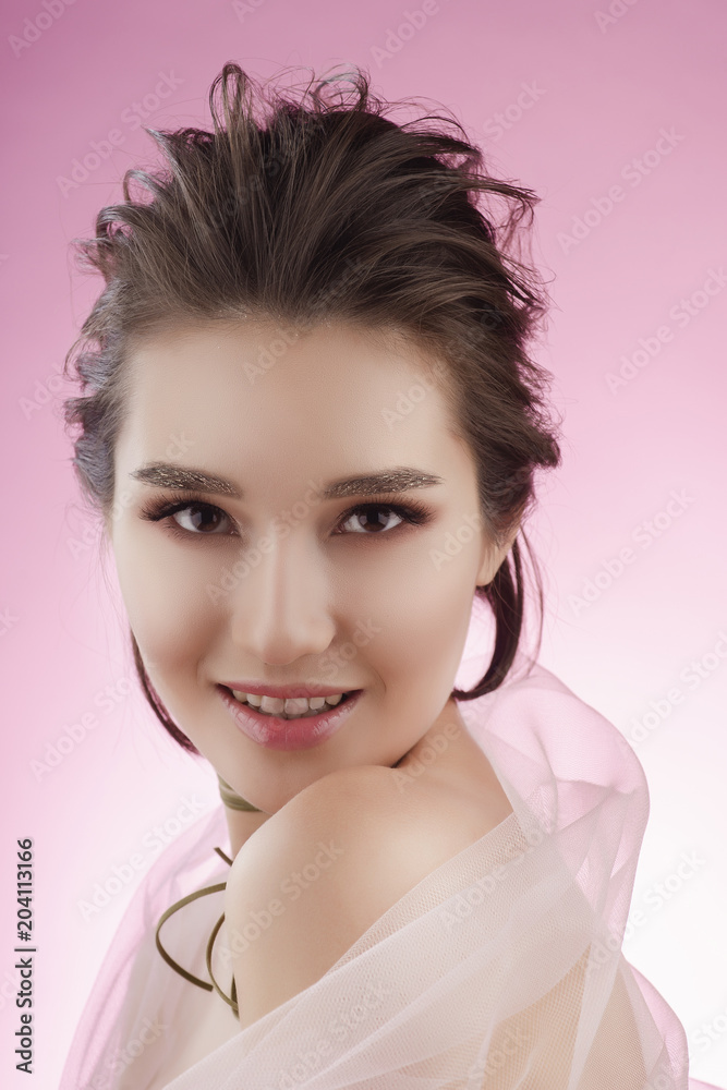 Closeup portrait of a beautiful smiling asian girl wearing pink veil on her shoulders and a choker on her neck Closeup portrait of a beautiful smiling asian girl wearing pink veil on her shoulders and a choker on her neck