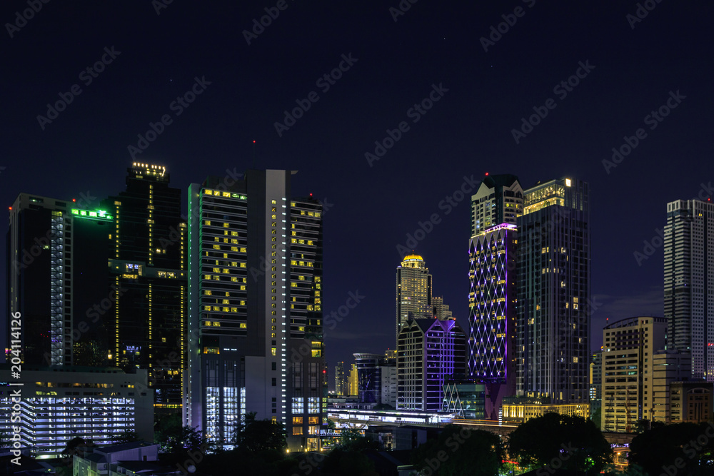 Cityscape at night in bangkok with tower and road, twilight sky Cityscape at night in bangkok with tower and road, twilight sky